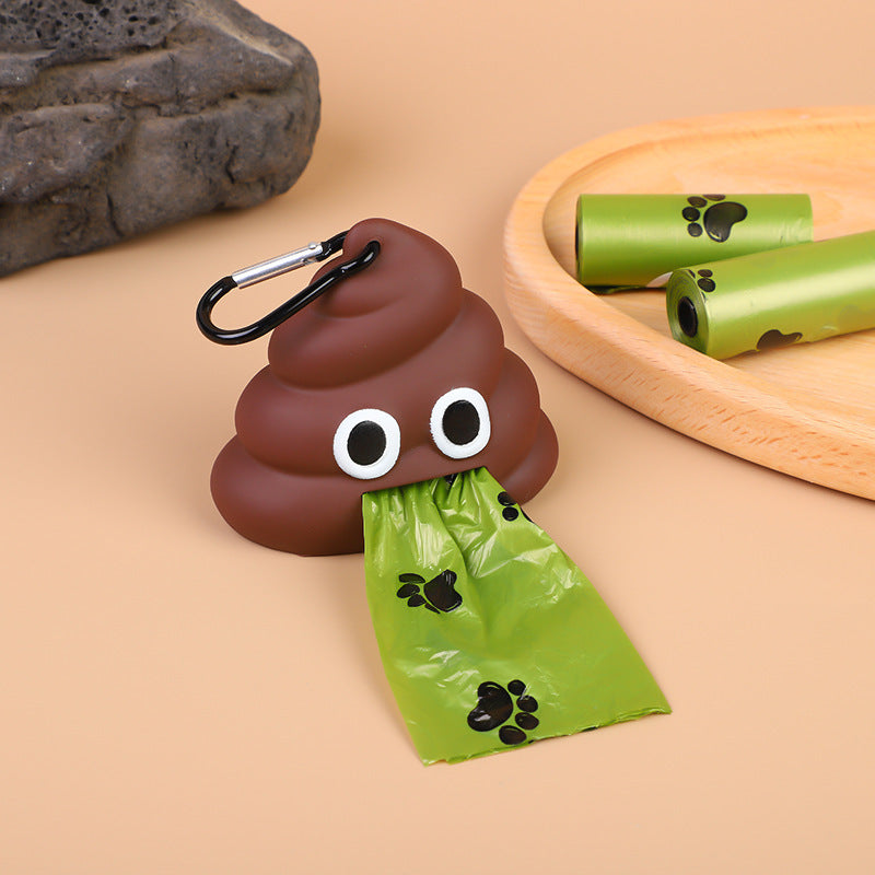 JMA Pet Goods brown poop shaped bag dispenser dispensing a green paw print dog waste bag