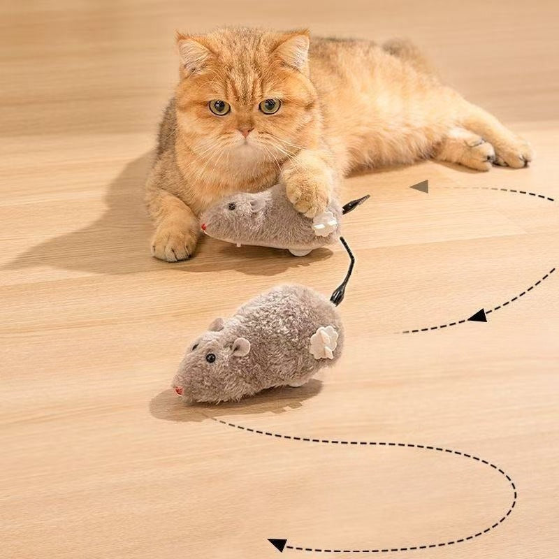 Cat catching a JMA Pet Goods wind-up plush mouse cat toy as another mouse runs in a winding path